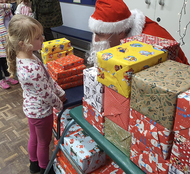 Santa giving a kid a present